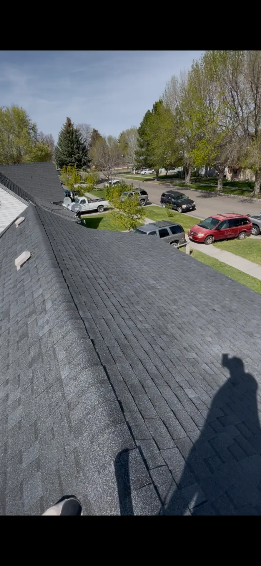 Completed dark shingle roof overlooking a Magic Valley neighborhood